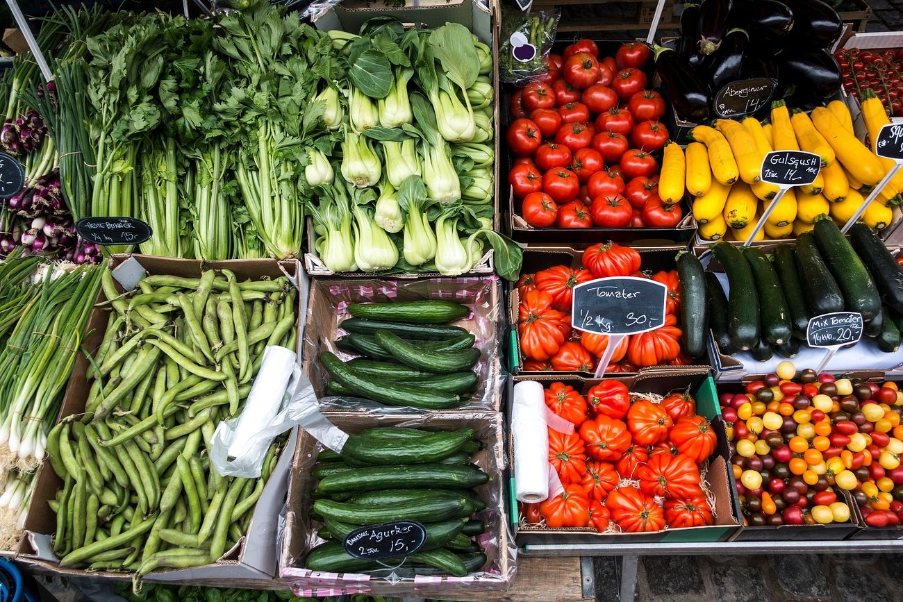 Vegetables stacked in crates on a market stall